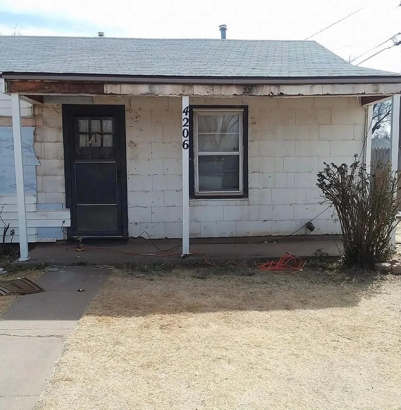 Exterior wall before All Star Remodeling & Construction siding and repair work