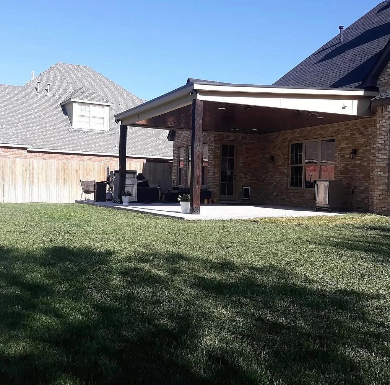 Backyard patio area after All Star Remodeling & Construction covered patio construction